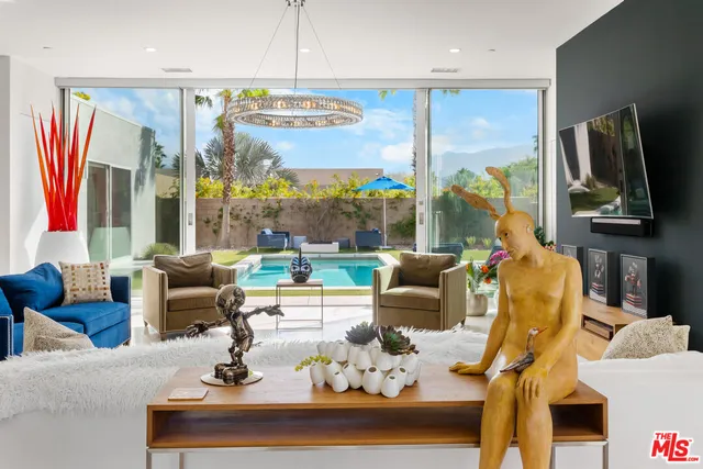 a view of a house with swimming pool and porch with furniture