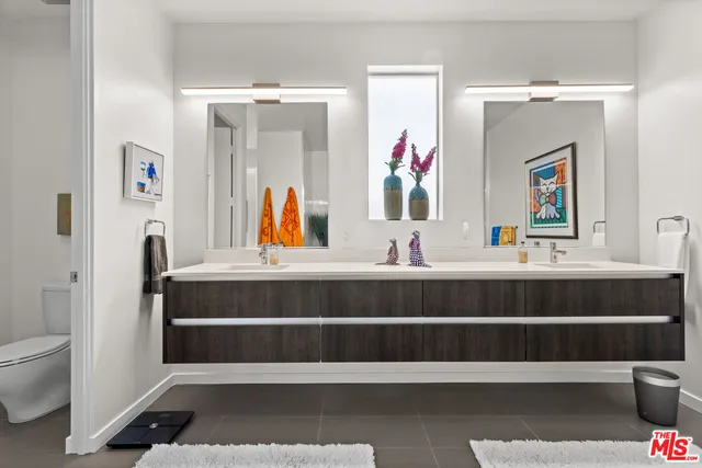 a view of a patio with table and chairs potted plants and large tree