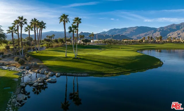 a living room with a table and a pool table