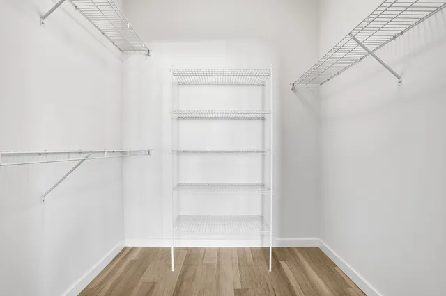 a bathroom with a tub sink shower and mirror
