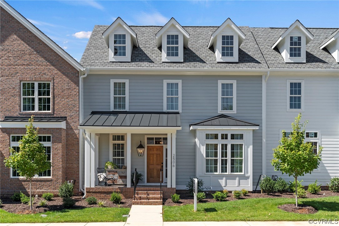 front view of a brick house with a yard