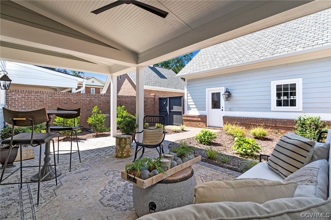 2542 Pagehurst Drive, Unit 8 Midlothian, VA 23113 - Photo 41 of 42 a view of a patio with couches table and chairs with potted plants
