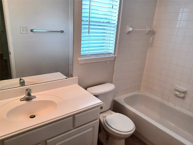 a bathroom with a sink a toilet and tub