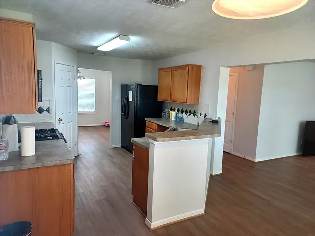 a kitchen with sink and refrigerator