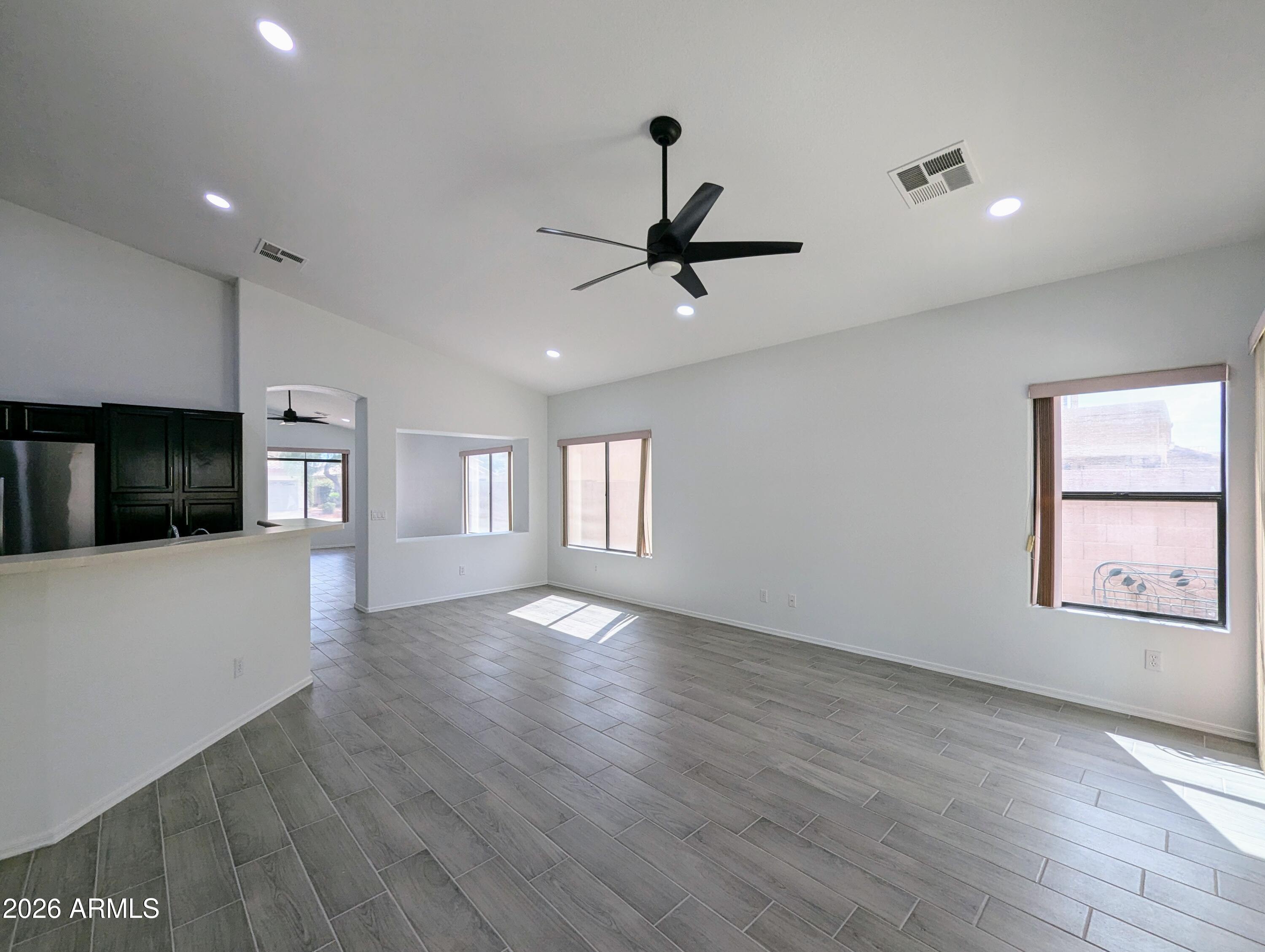 5424 West Wagoner Road Glendale, AZ 85308 - Photo 11 of 37 a view of an empty room with window and wooden floor