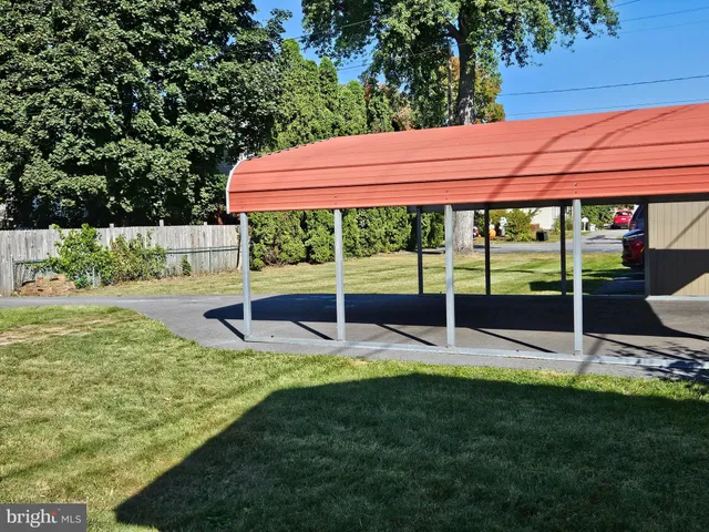 a view of a chair and table in the garden
