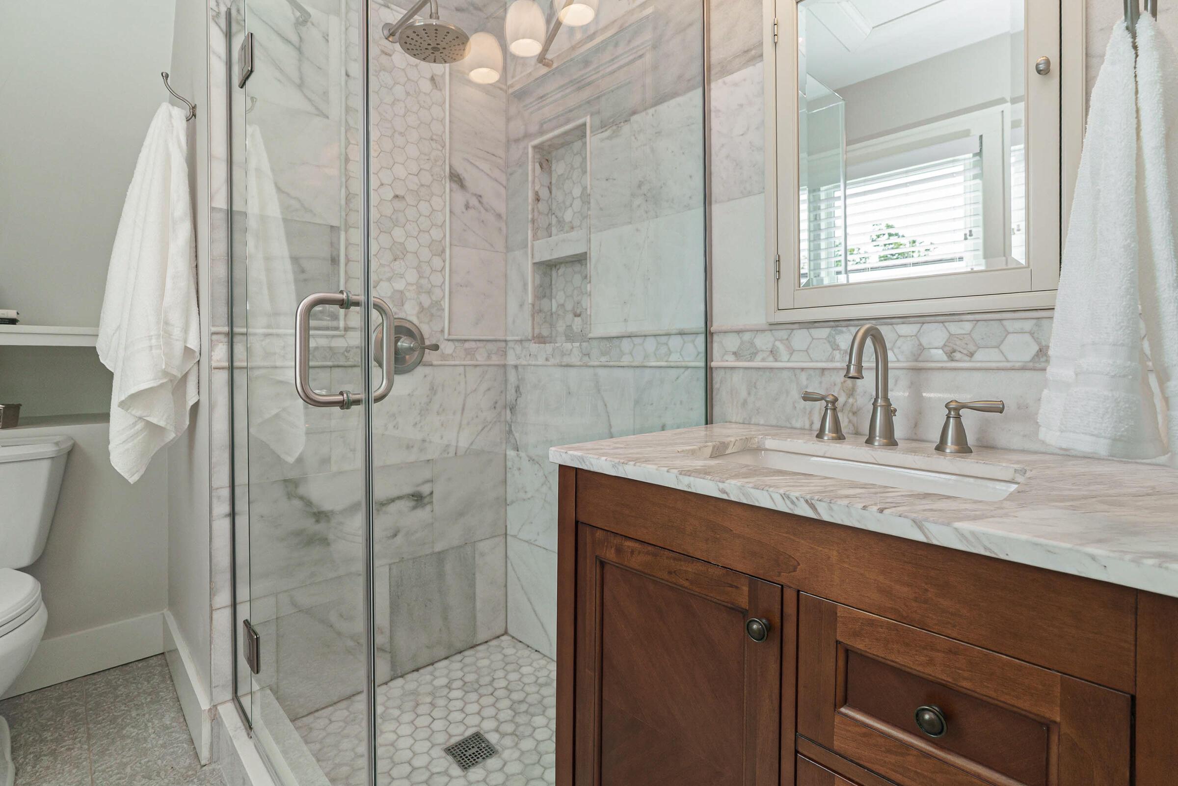 163 Garden Road Columbus, OH 43214 - Photo 28 of 46 New glass enclosed tile shower in the updated primary suite bathroom.