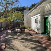 a view of a house with backyard and sitting area
