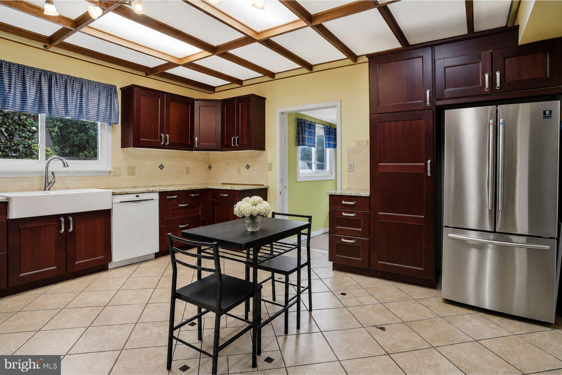 8965 Poorhouse Road Port Tobacco, MD 20677 - Photo 6 of 18 a kitchen with stainless steel appliances kitchen island granite countertop a refrigerator and a sink