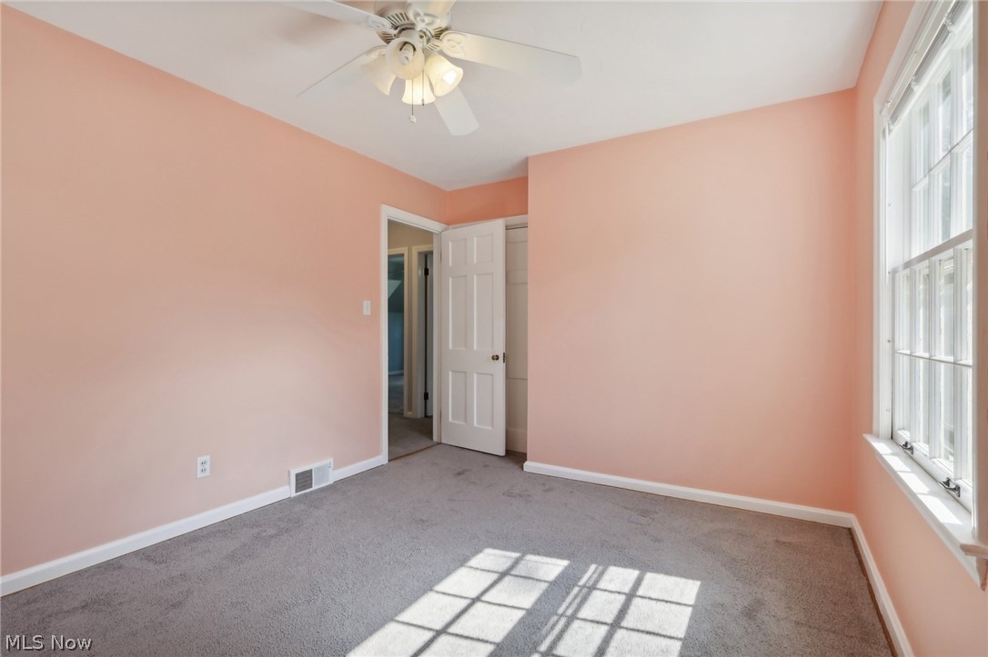 2620 Charney Road Cleveland, OH 44118 - Photo 24 of 43 Unfurnished bedroom featuring multiple windows, carpet flooring, and ceiling fan