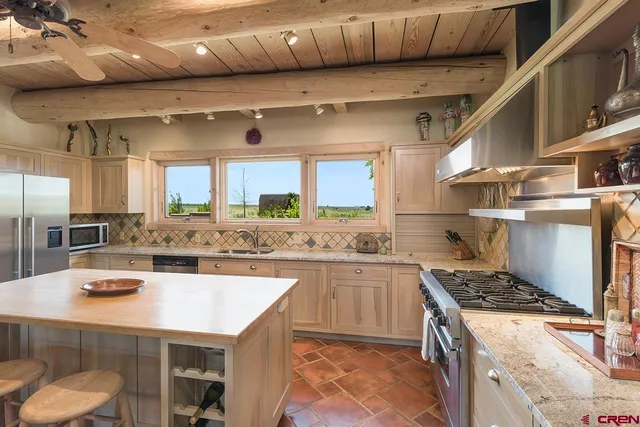 a kitchen with a sink a stove and cabinets