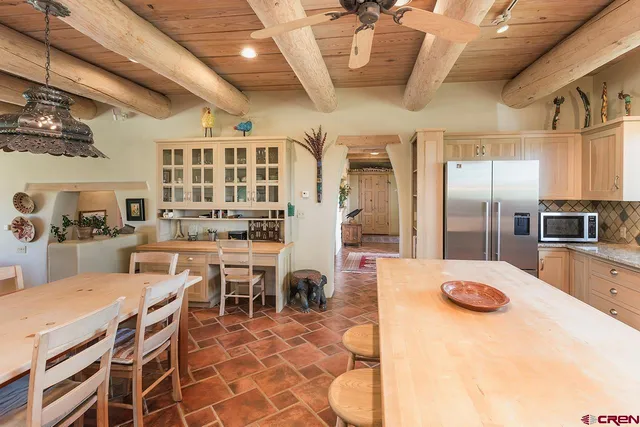 a large kitchen with a table and chairs