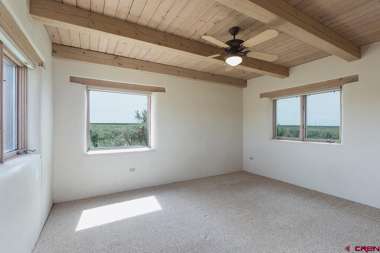 6445 County Road 100 Hesperus, CO 81326 - Photo 23 of 35 an empty room with a window and a ceiling fan