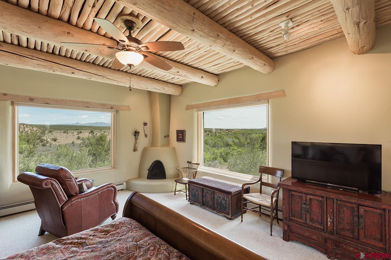 6445 County Road 100 Hesperus, CO 81326 - Photo 7 of 35 a living room with furniture a flat screen tv and a floor to ceiling window