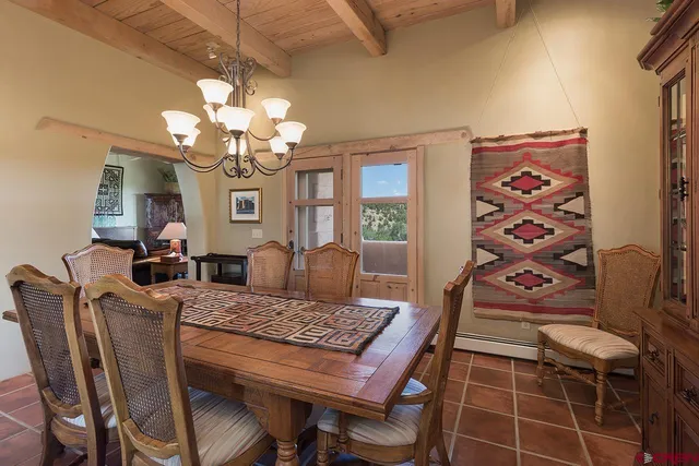 a view of a dining room with furniture and a chandelier