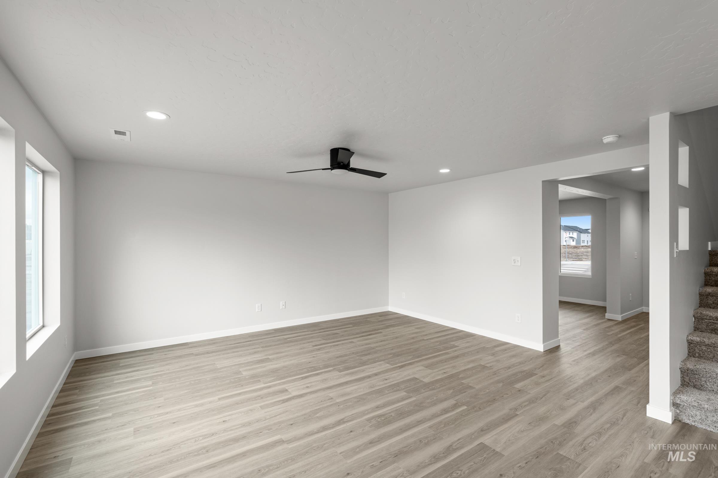 14056 Shiny Spruce Street Caldwell, ID 83607 - Photo 8 of 25 Spacious room featuring wood-finish flooring, recessed lighting, and a modern ceiling fan