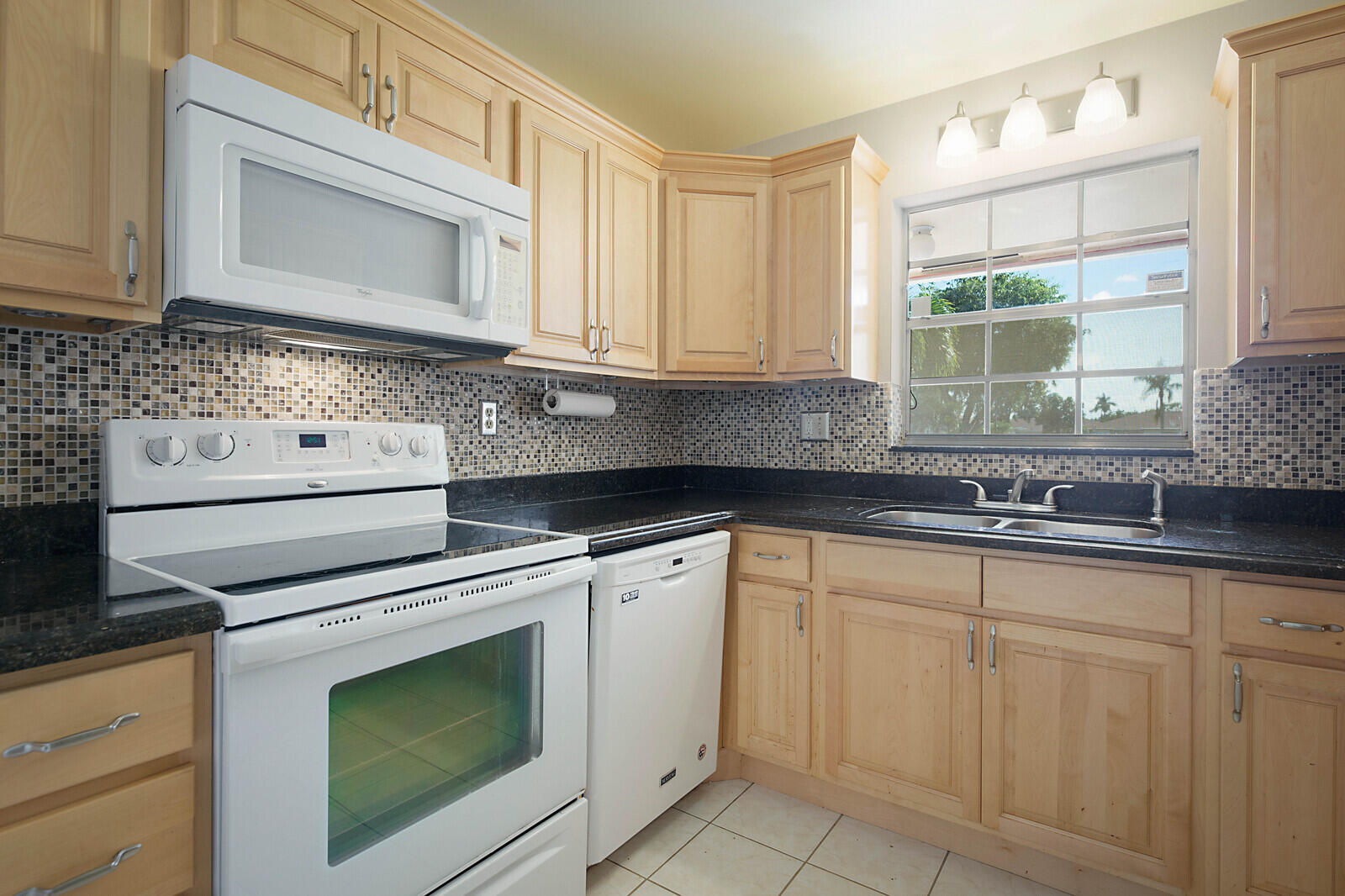 4525 Northwest 3rd Street, Unit D Delray Beach, FL 33445 - Photo 11 of 25 a kitchen with white cabinets and white appliances