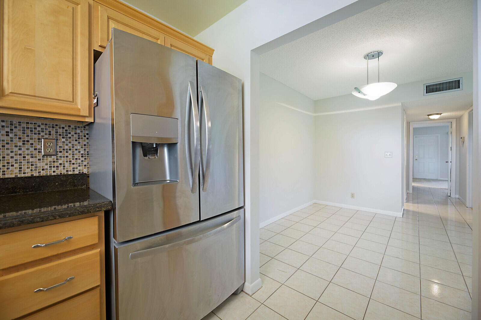 4525 Northwest 3rd Street, Unit D Delray Beach, FL 33445 - Photo 13 of 25 a view of a refrigerator in kitchen and an empty room