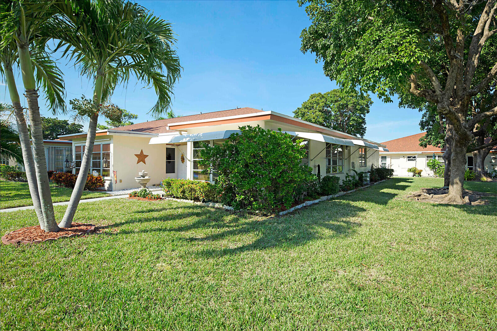 4525 Northwest 3rd Street, Unit D Delray Beach, FL 33445 - Photo 23 of 25 a view of a house with backyard and a tree