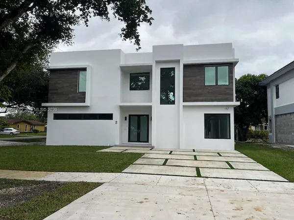 a front view of a house with yard
