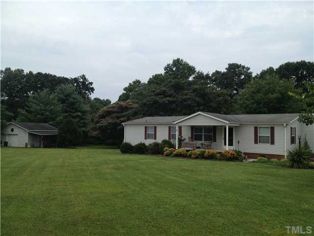 206 West O Painter Road Timberlake, NC 27583 - Photo 1 of 16 a front view of a house with a garden