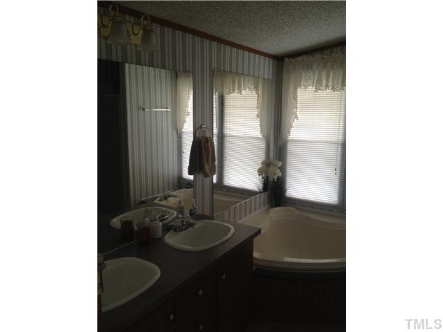 206 West O Painter Road Timberlake, NC 27583 - Photo 14 of 16 a bathroom with a sink and a mirror