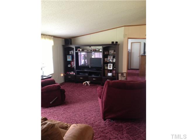 206 West O Painter Road Timberlake, NC 27583 - Photo 15 of 16 a living room with furniture and a flat screen tv