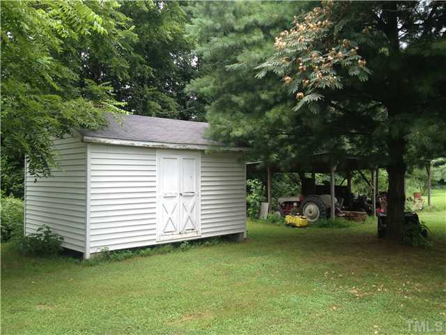 206 West O Painter Road Timberlake, NC 27583 - Photo 5 of 16 a view of a patio with table and chairs and a large tree