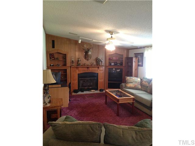 206 West O Painter Road Timberlake, NC 27583 - Photo 7 of 16 a living room with furniture and a fireplace