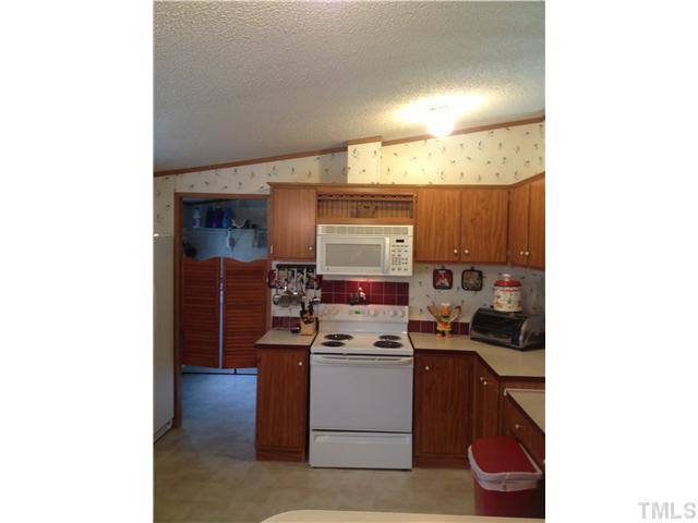 206 West O Painter Road Timberlake, NC 27583 - Photo 10 of 16 a kitchen with a sink cabinets and appliances
