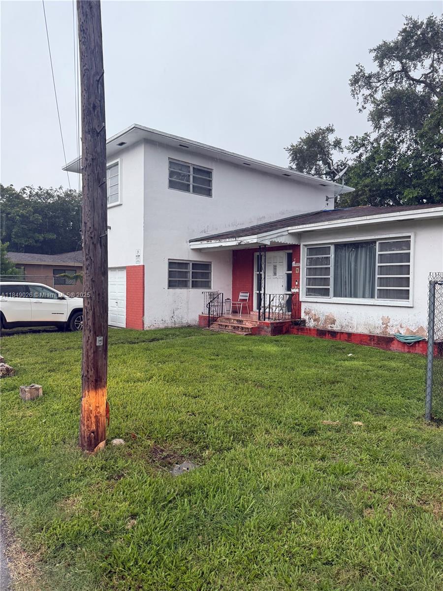 a front view of house with yard and outdoor seating