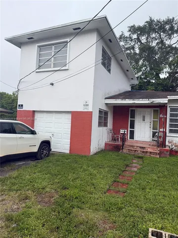 a front view of house with yard and outdoor seating