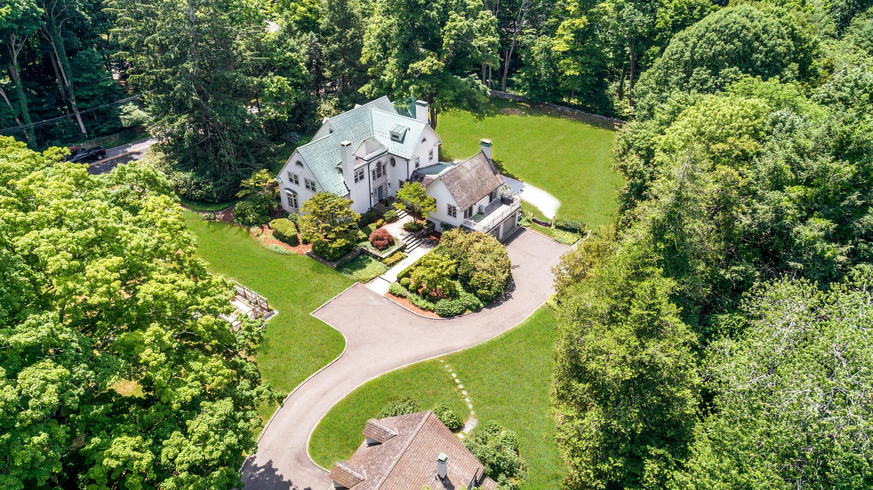 343-335 Wahackme Road New Canaan, CT 06840 - Photo 1 of 32 an aerial view of a house with a swimming pool