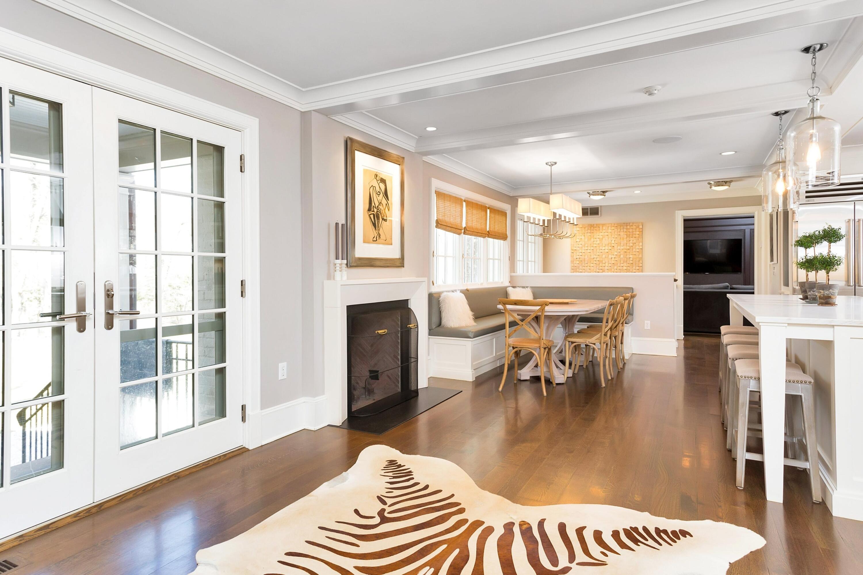 343-335 Wahackme Road New Canaan, CT 06840 - Photo 13 of 32 a living room with furniture and a dining table with wooden floor