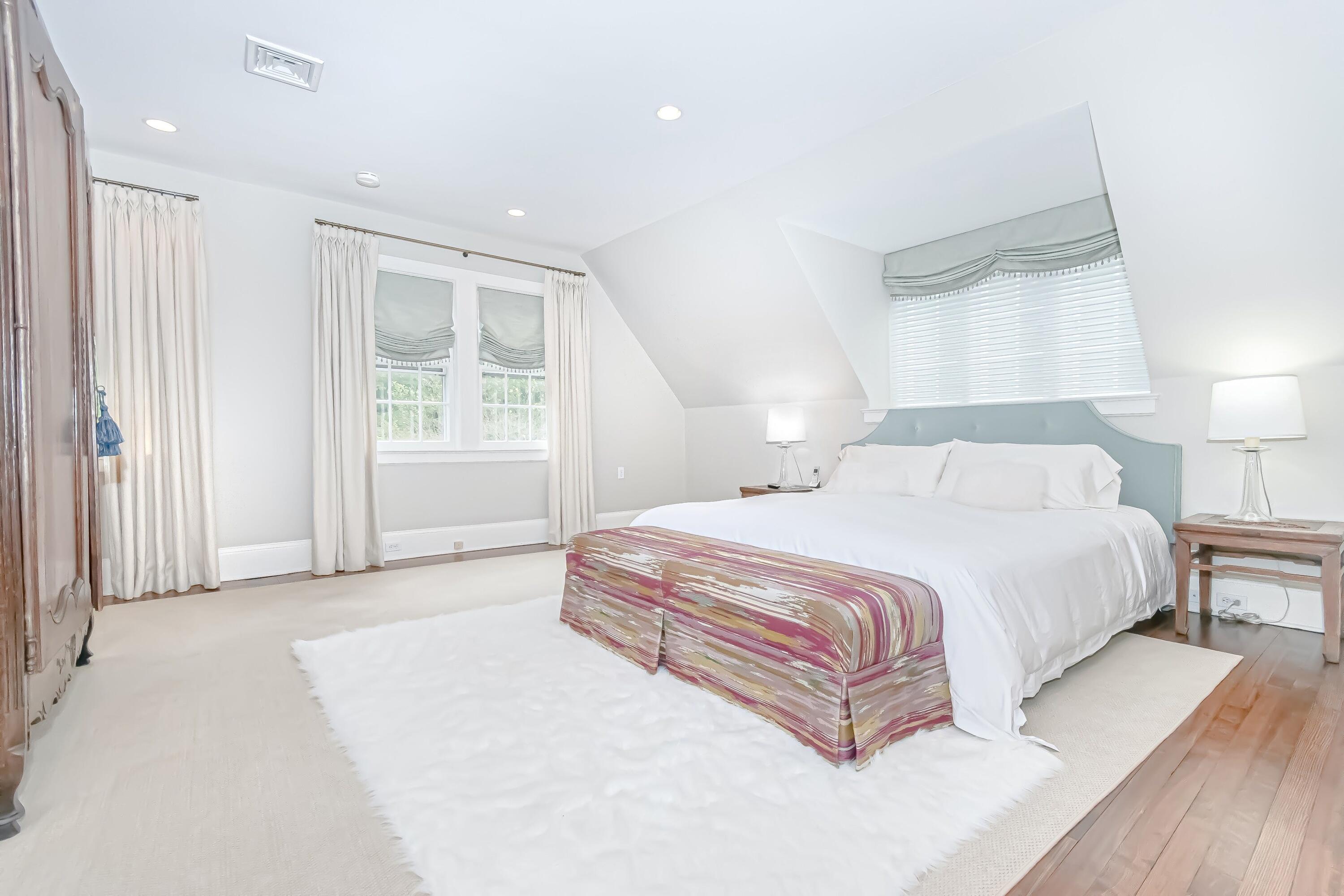343-335 Wahackme Road New Canaan, CT 06840 - Photo 16 of 32 a spacious bedroom with a large bed and a window