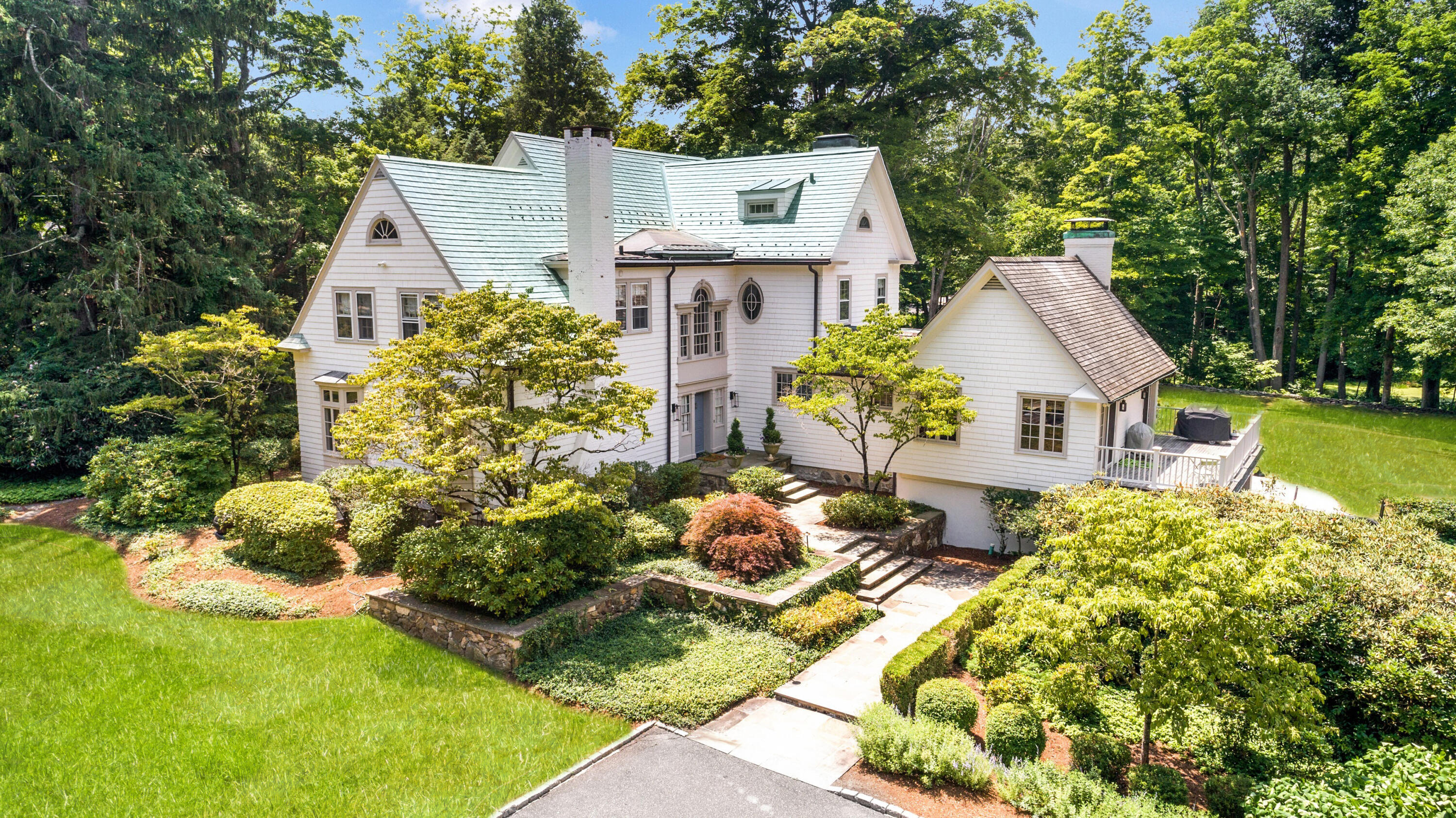 343-335 Wahackme Road New Canaan, CT 06840 - Photo 2 of 32 a front view of a house with garden