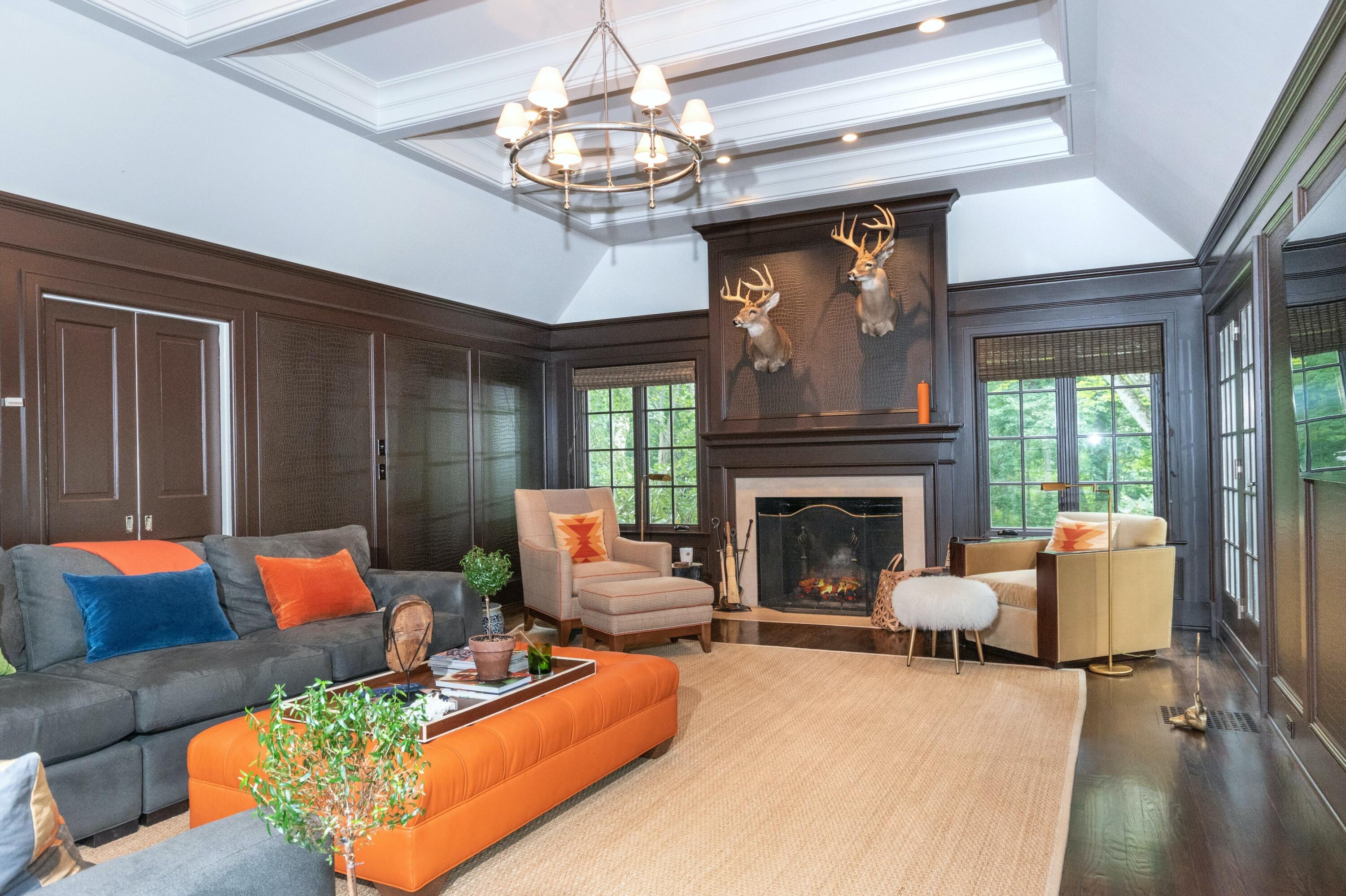 343-335 Wahackme Road New Canaan, CT 06840 - Photo 10 of 32 a living room with furniture chandelier and a fireplace