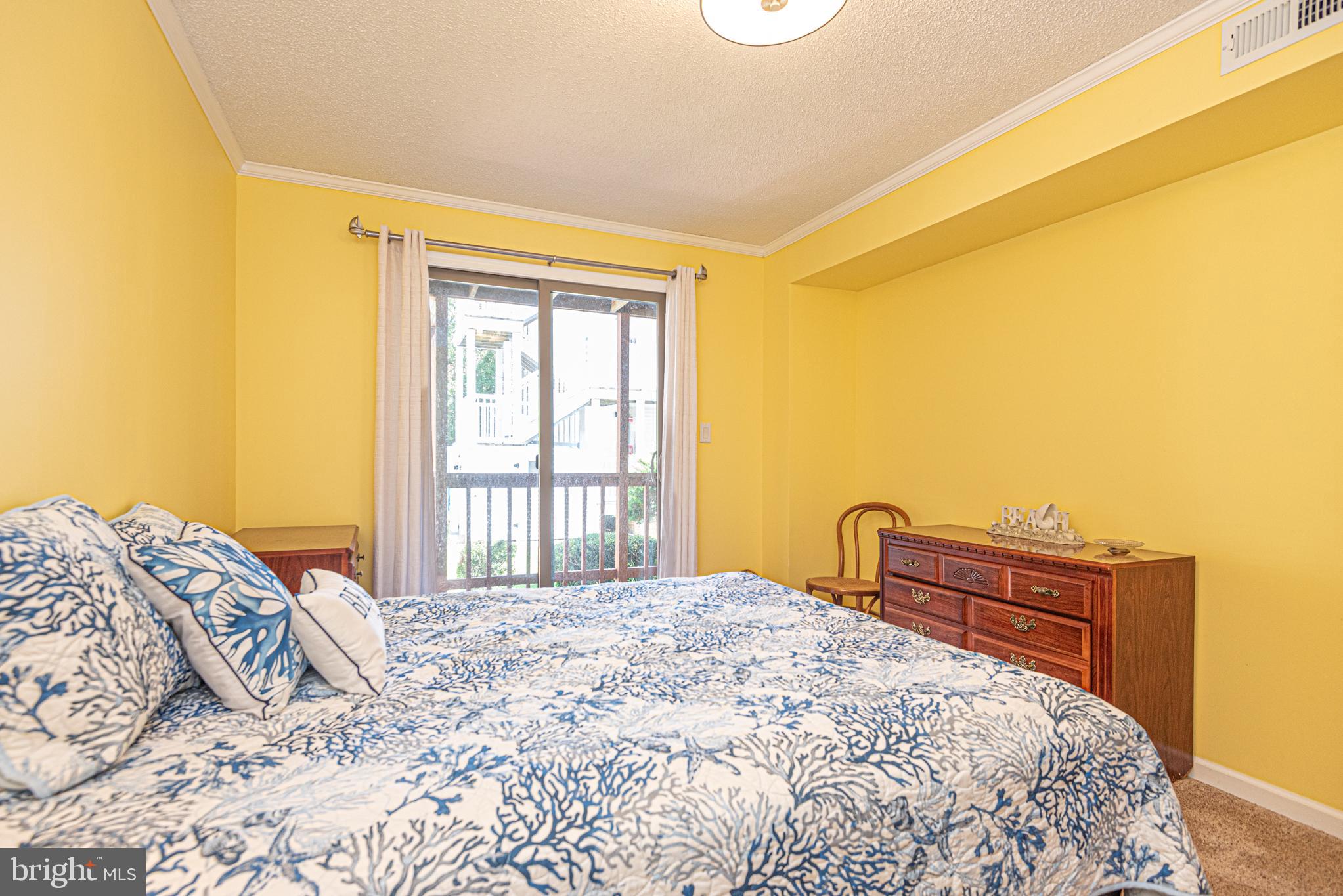 14405 Tunnel Avenue, Unit 112 Ocean City, MD 21842 - Photo 12 of 32 a bedroom with a bed and a window