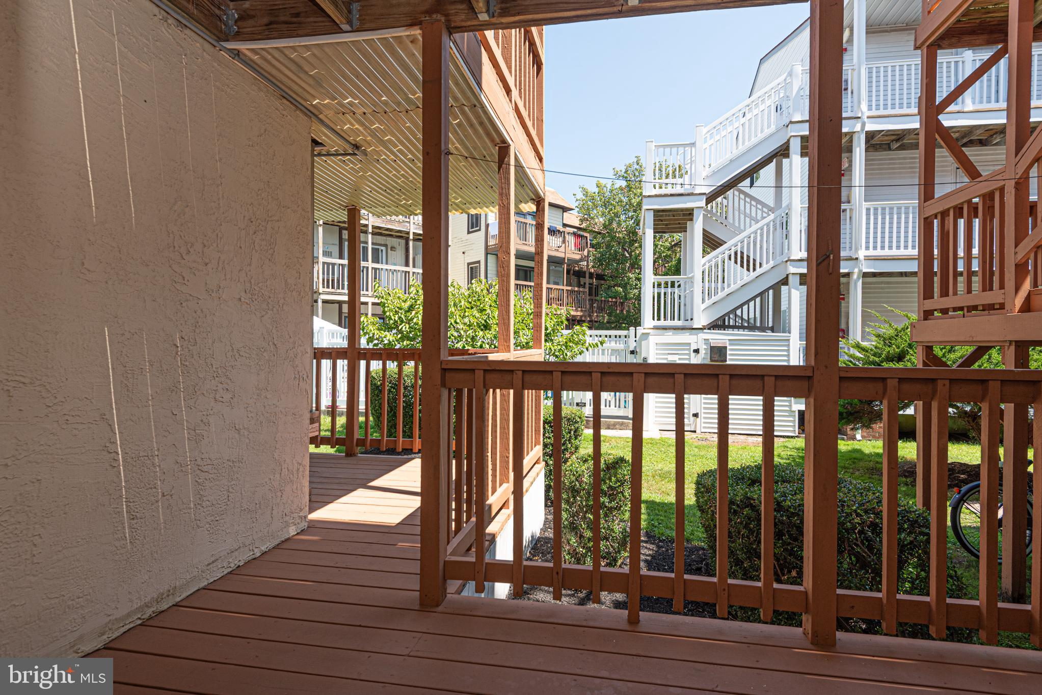14405 Tunnel Avenue, Unit 112 Ocean City, MD 21842 - Photo 13 of 32 a view of a balcony with wooden floor