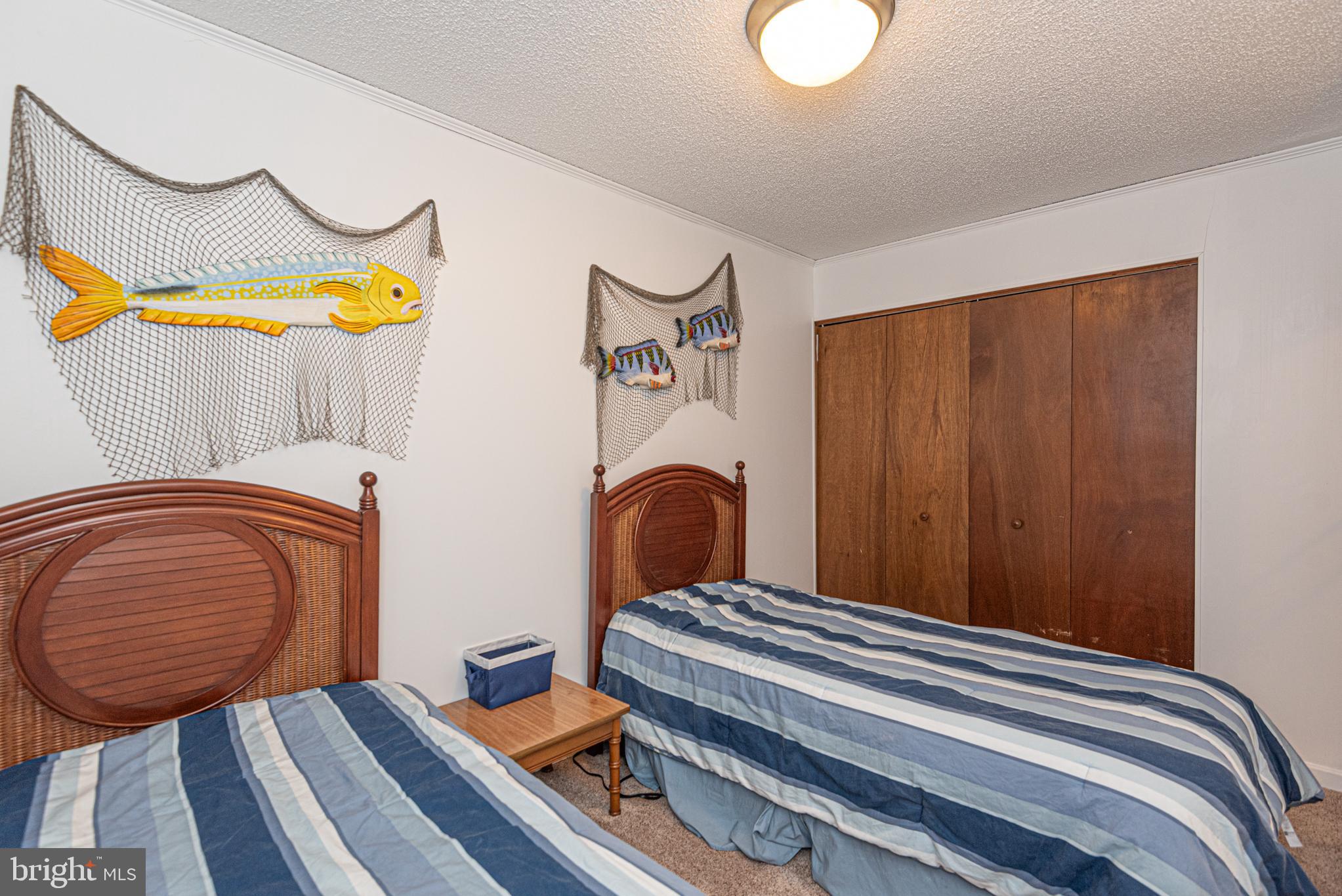 14405 Tunnel Avenue, Unit 112 Ocean City, MD 21842 - Photo 21 of 32 a bedroom with bed and a window