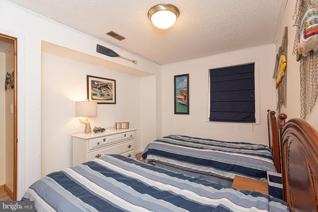 a bedroom with a bed and a mirror