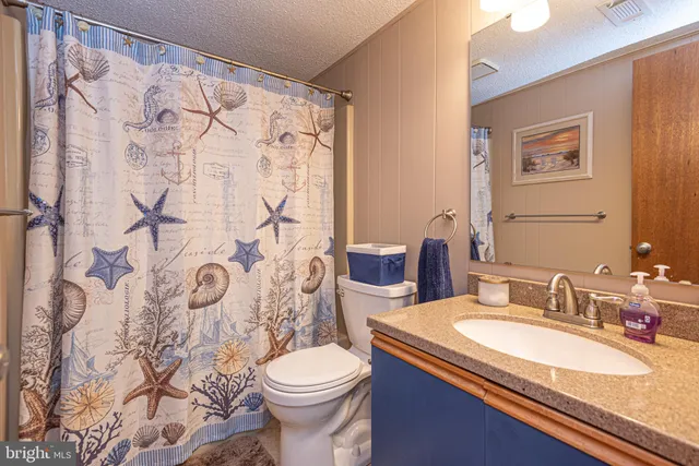 a bath room with a toilet sink and shower
