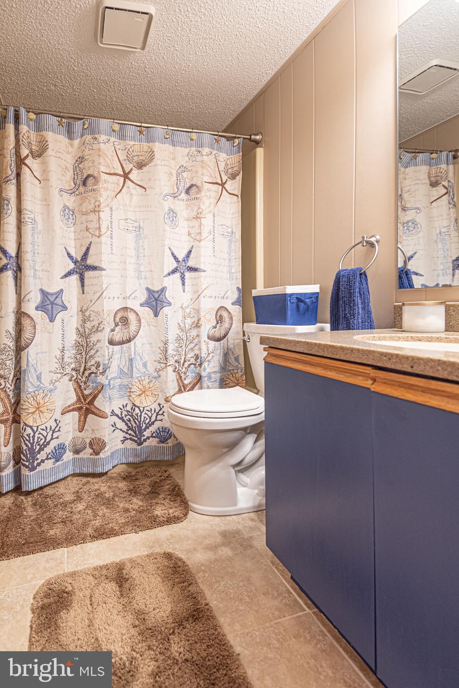 14405 Tunnel Avenue, Unit 112 Ocean City, MD 21842 - Photo 26 of 32 a bath room with a toilet sink and shower