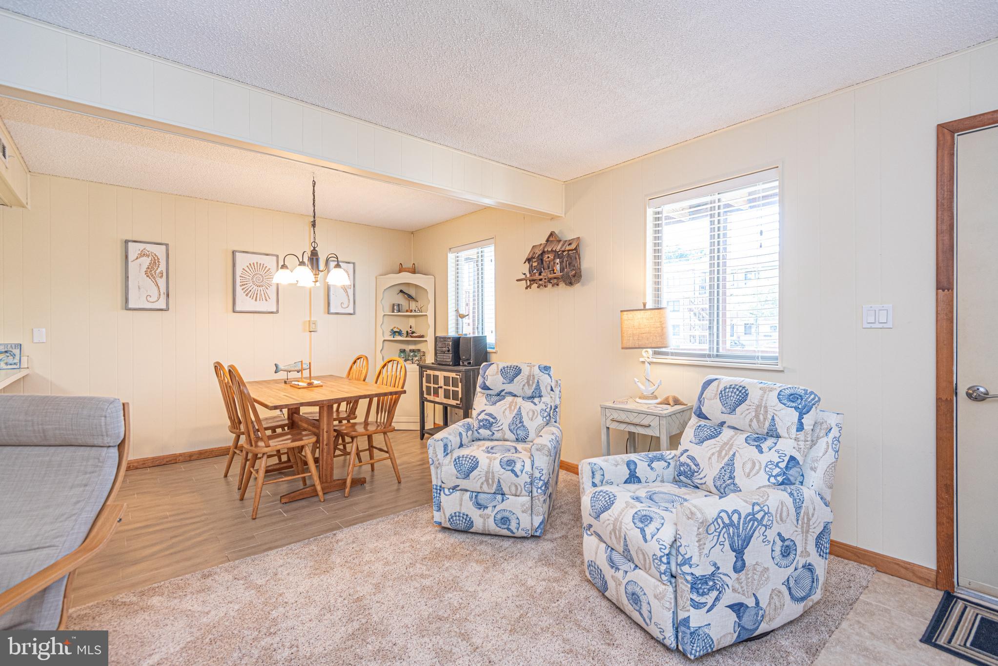 14405 Tunnel Avenue, Unit 112 Ocean City, MD 21842 - Photo 6 of 32 a living room with furniture and a large window