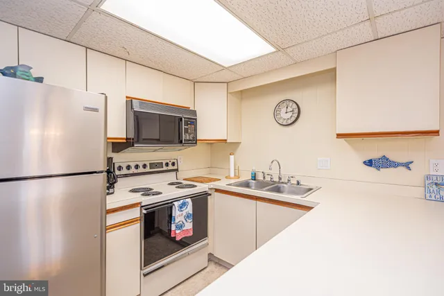 a kitchen with a refrigerator a stove top oven a sink and dishwasher