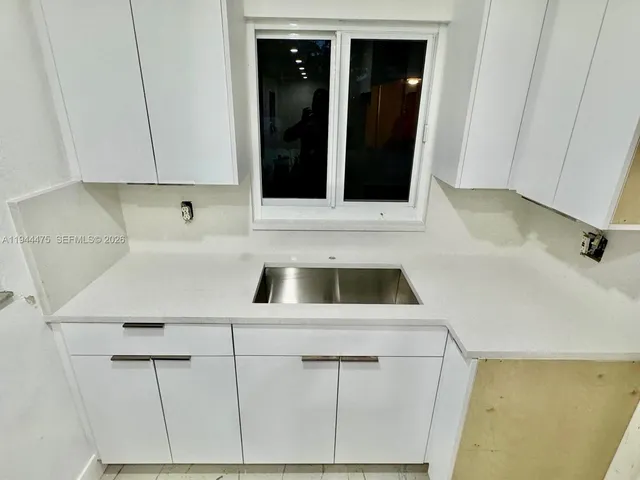 a kitchen with a sink and cabinets