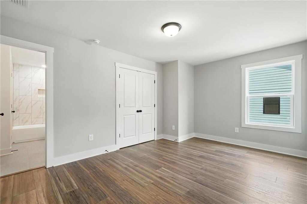 133 Old Alabama Road Southeast Emerson, GA 30137 - Photo 17 of 40 an empty room with wooden floor and windows