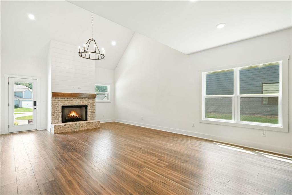 133 Old Alabama Road Southeast Emerson, GA 30137 - Photo 3 of 40 a view of an empty room with wooden floor fireplace and a window