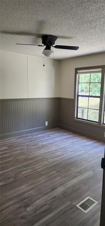 19865 Southwest 5th Place Dunnellon, FL 34431 - Photo 57 of 78 a view of empty room with wooden floor and fan