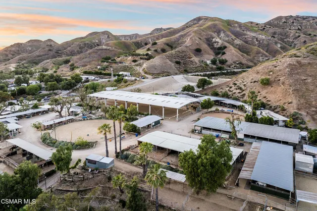 an aerial view of a house with a mountain